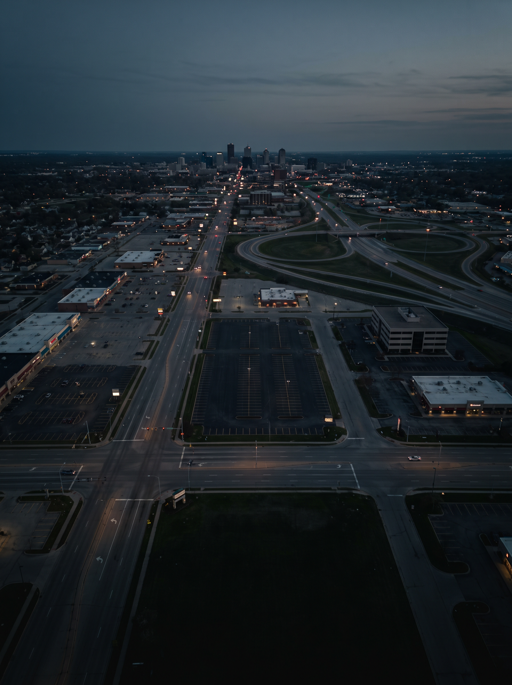 Aerial view of an American city spread apart by parking lots and wide roads