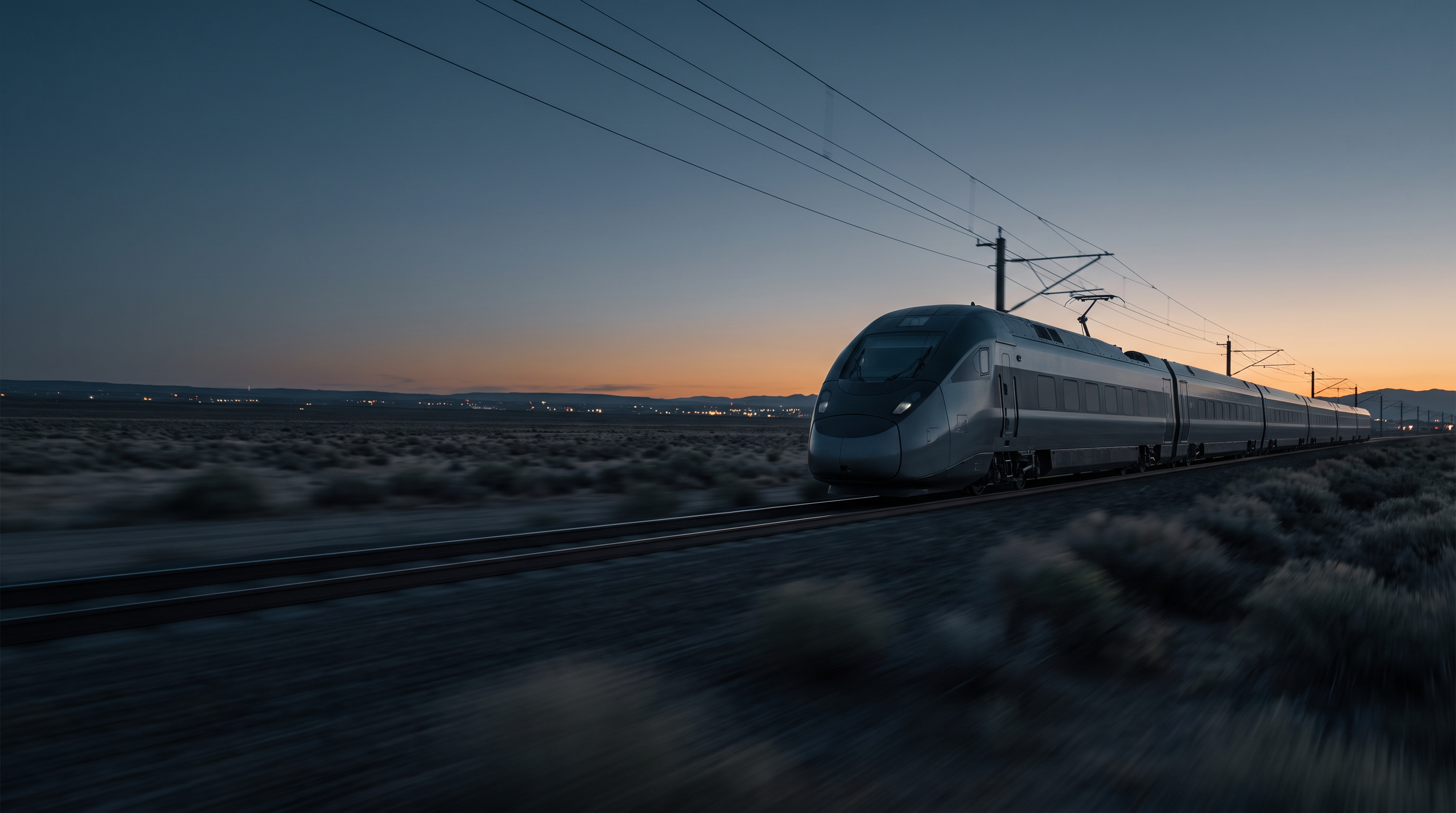 A modern electric train crossing the American landscape at blue hour